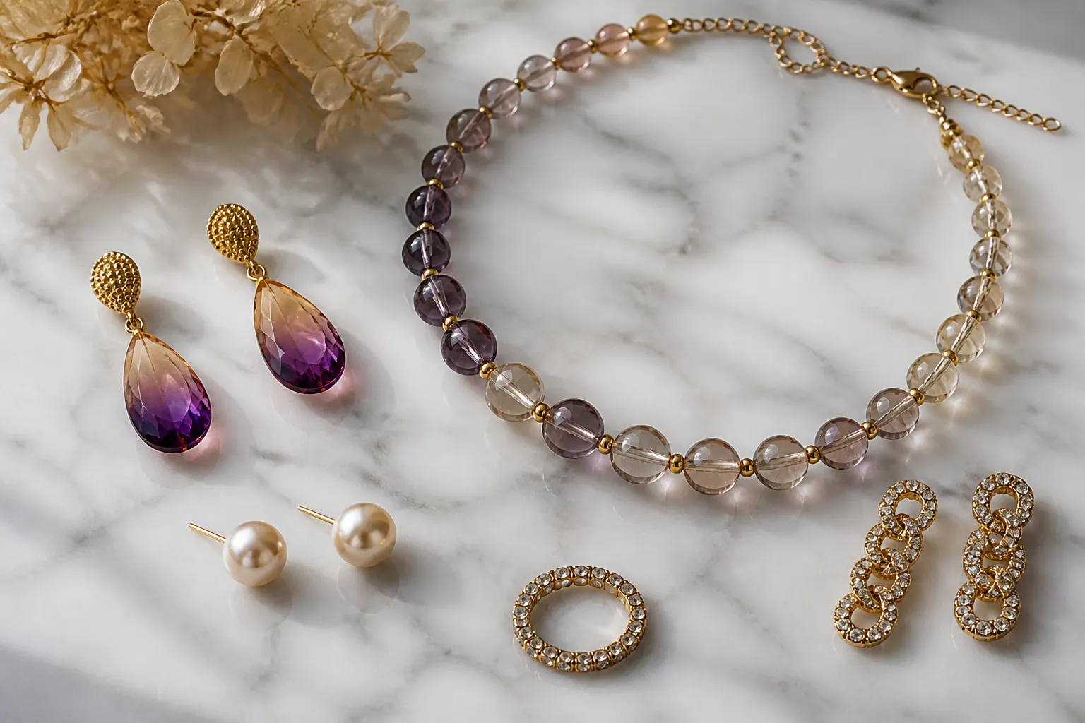 bijoux tendances - Photorealistic flat-lay of a curated jewelry collection on a white marble surface — gradient crystal drop earrings, two-tone glass bead necklace, pearl stud earrings, and a rhinestone set arranged with natural daylight from a side window, documentary product photography style, no text