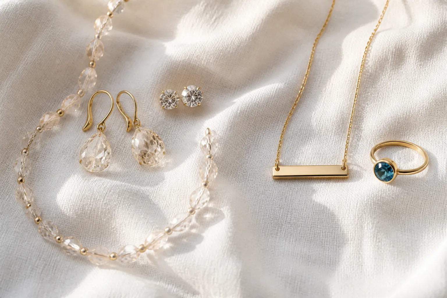 custom jewelry - Photorealistic flat-lay comparison of OEM fashion jewelry pieces (gold-plated crystal drop earrings, rhinestone studs, glass bead necklace set) alongside retail personalized pieces (engraved necklace, birthstone ring), showing the material and style contrast